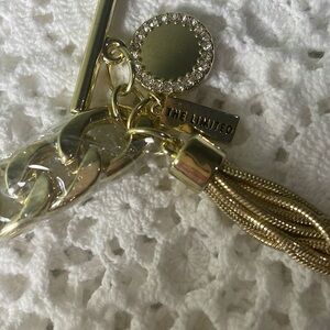 The Limited Gold tone toggle bracelet with a tassel and charms New in wrap